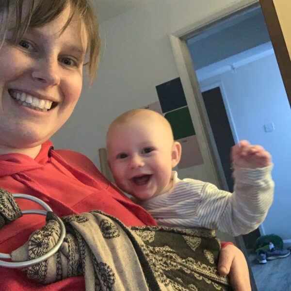woman with baby in sling Postnatal care sleep consultancy Northampton